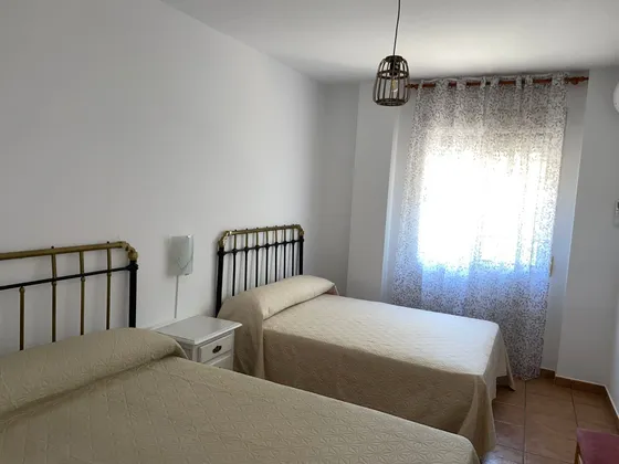 Habitación equipada con aire acondicionado y mobiliario cómodo.
